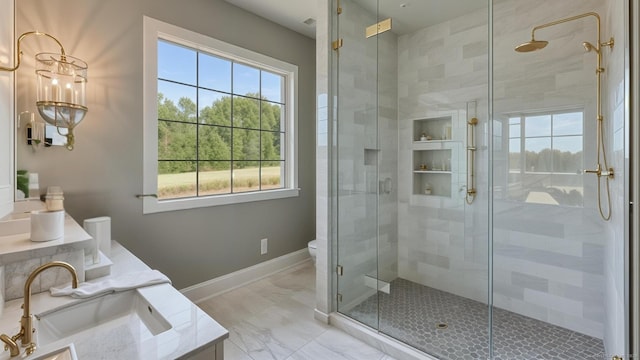 bathroom with vanity, a shower with shower door, and toilet