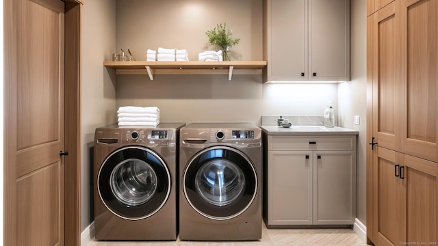 washroom with cabinets and washer and clothes dryer