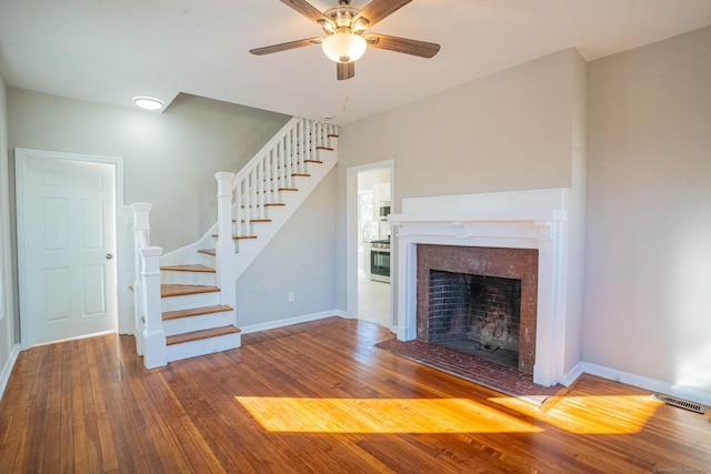 unfurnished living room featuring ceiling fan and hardwood / wood-style floors