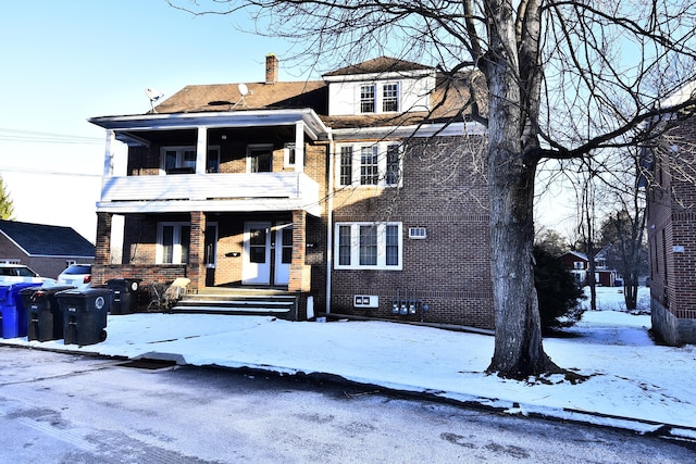 view of front of house with covered porch and a balcony