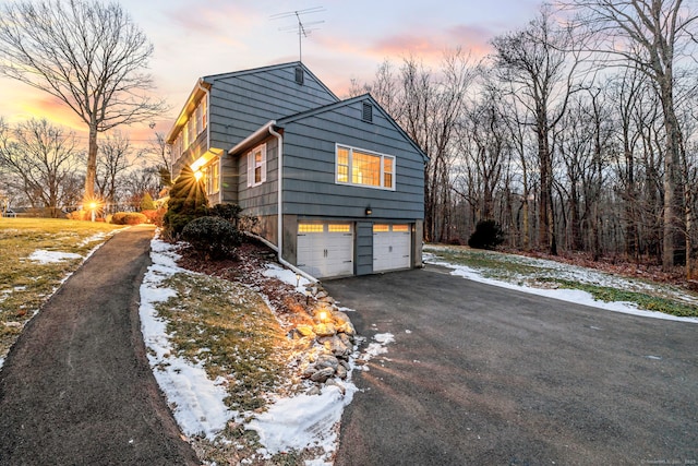 view of snowy exterior with a garage