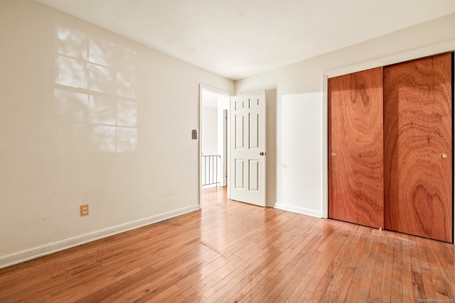 unfurnished bedroom featuring a closet and light hardwood / wood-style flooring