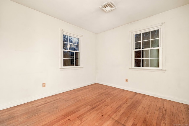 unfurnished room with hardwood / wood-style floors