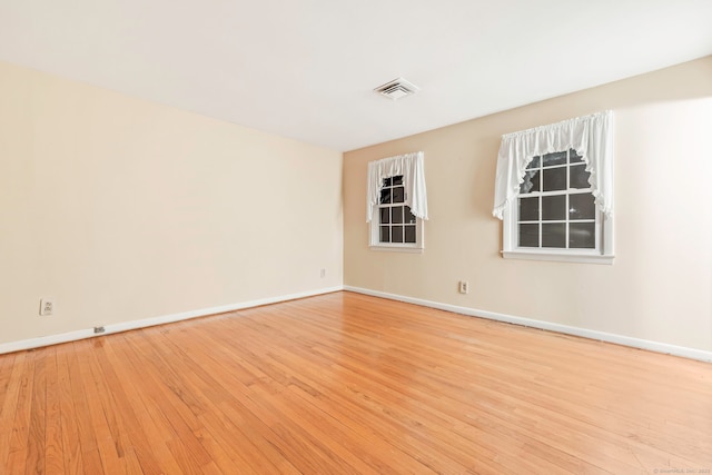 spare room featuring light hardwood / wood-style flooring