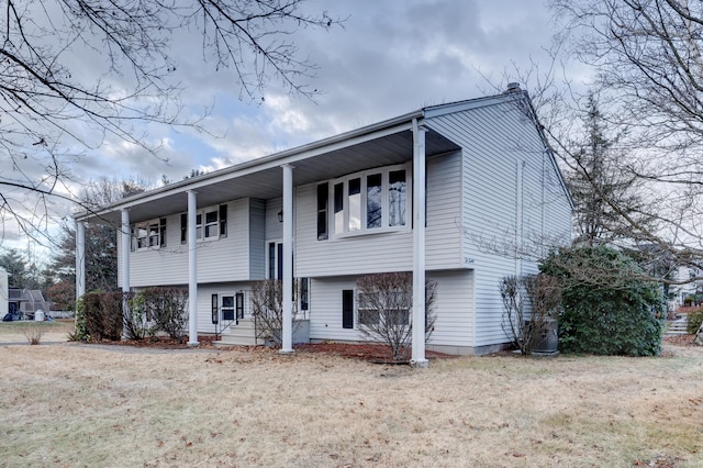 view of front of property featuring a front yard and central AC unit