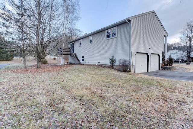 rear view of house with a yard and a garage