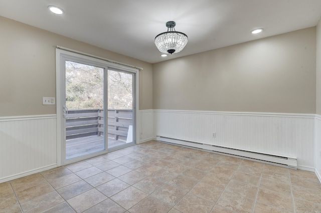 unfurnished room featuring an inviting chandelier, light tile patterned floors, and a baseboard heating unit