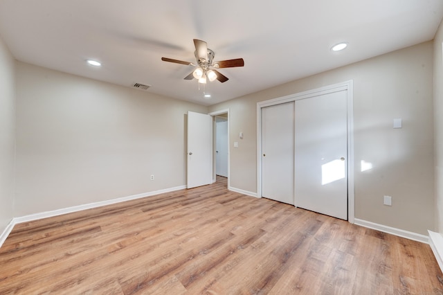 unfurnished bedroom with ceiling fan, a closet, and light hardwood / wood-style flooring