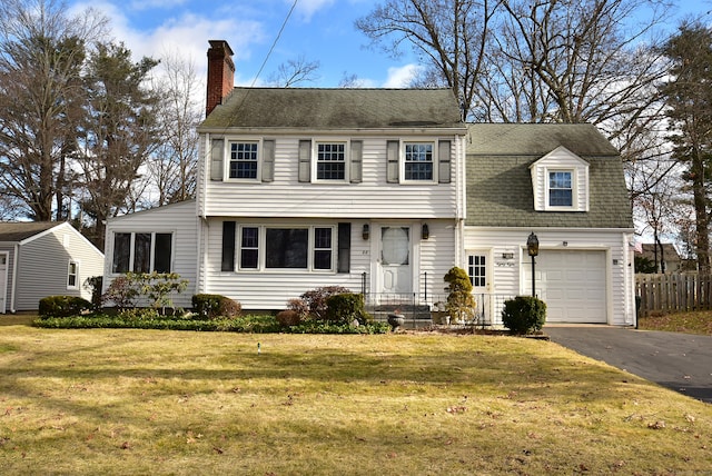 view of front of house with a garage and a front lawn