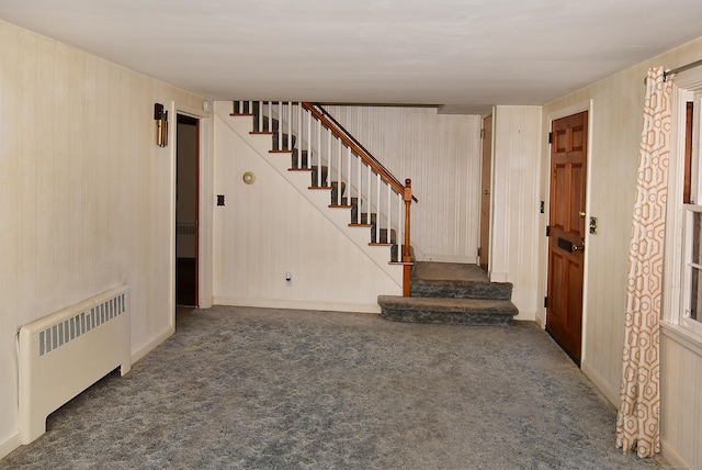 interior space with radiator and dark colored carpet