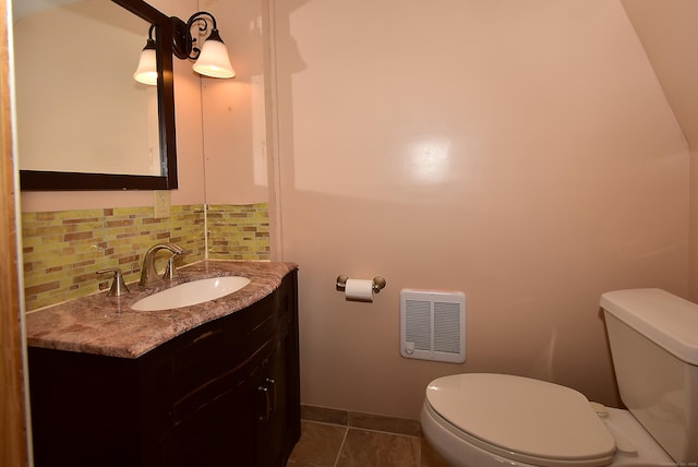 bathroom featuring backsplash, tile patterned floors, vanity, heating unit, and toilet