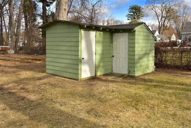 view of outdoor structure featuring a lawn