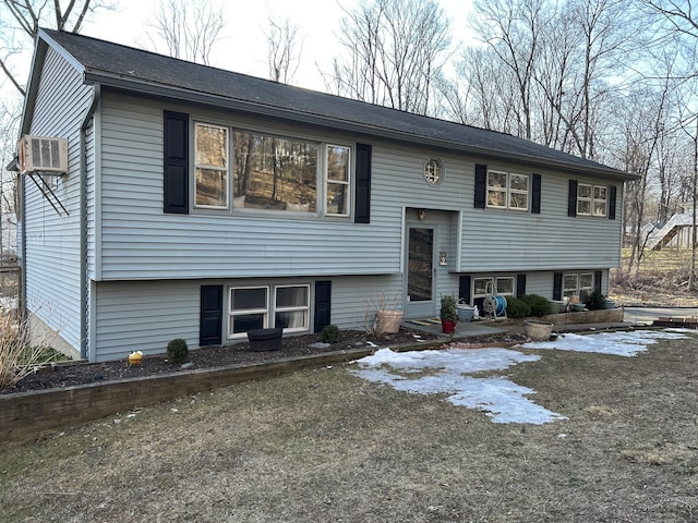 split foyer home with a wall mounted air conditioner