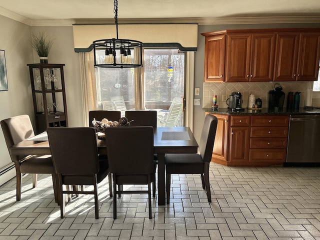 dining room featuring brick floor, ornamental molding, and an inviting chandelier