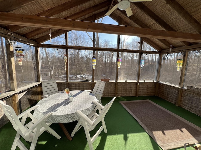 sunroom / solarium with a ceiling fan and lofted ceiling with beams