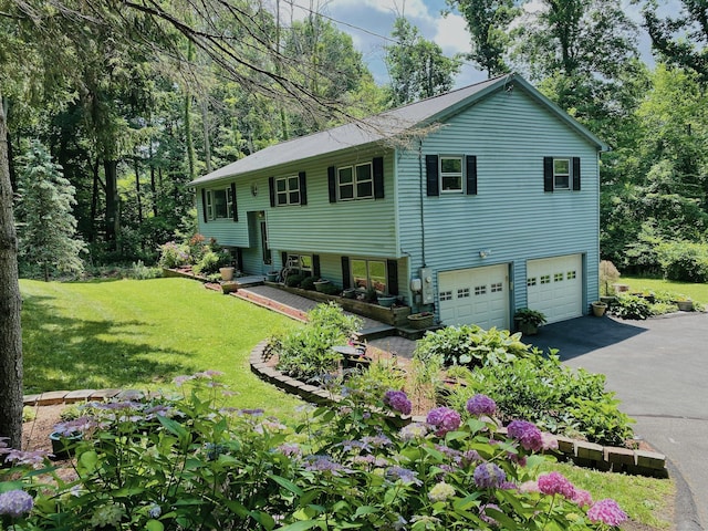 bi-level home featuring driveway, an attached garage, and a front lawn