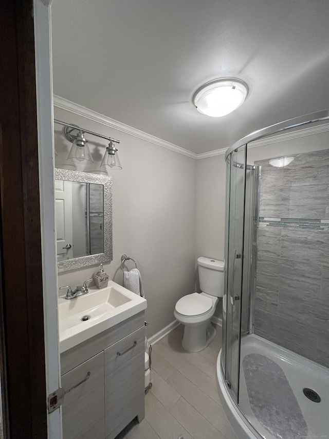 bathroom featuring ornamental molding, a stall shower, vanity, and toilet