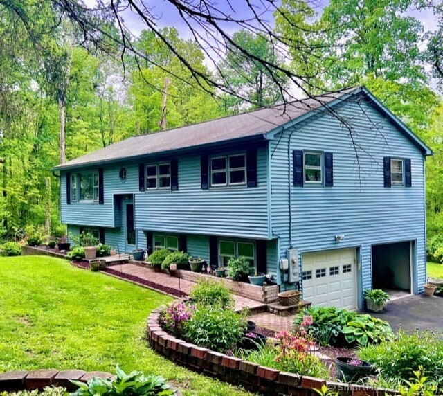 7 Varian Dr, Danbury, CT 06811 - back of house with a garage, a yard, and asphalt driveway