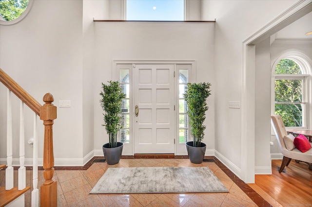 tiled entrance foyer with a high ceiling