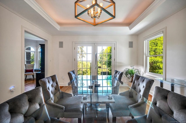 living room featuring a tray ceiling, hardwood / wood-style floors, and an inviting chandelier