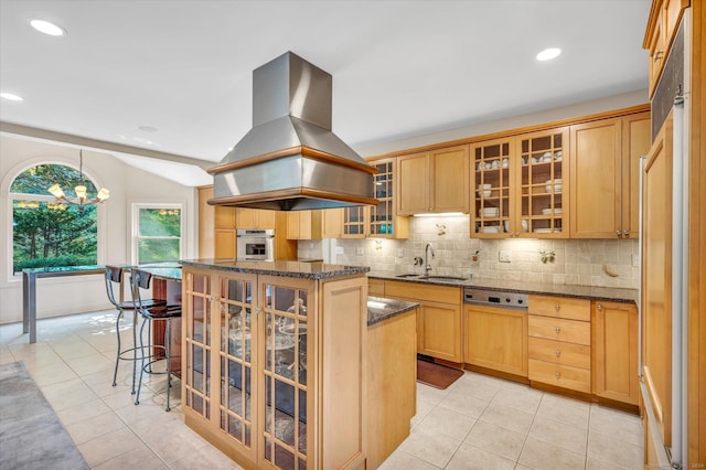 kitchen with island exhaust hood, sink, an inviting chandelier, a center island, and oven