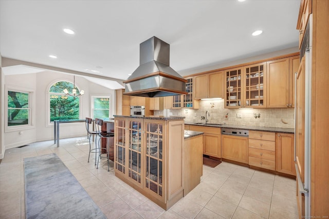 kitchen featuring a center island, oven, sink, island range hood, and a kitchen bar