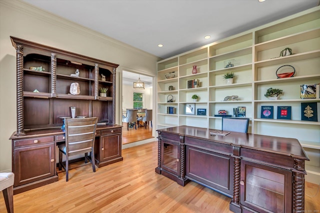 office space with light hardwood / wood-style floors and crown molding