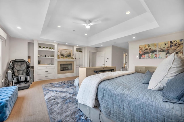 bedroom with a tray ceiling and ceiling fan