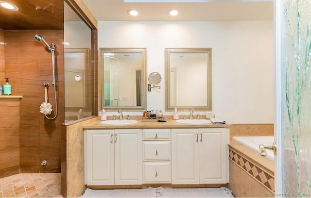 bathroom featuring vanity, plus walk in shower, and a skylight