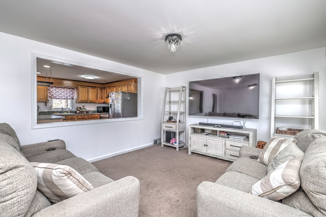 living room with sink and light colored carpet