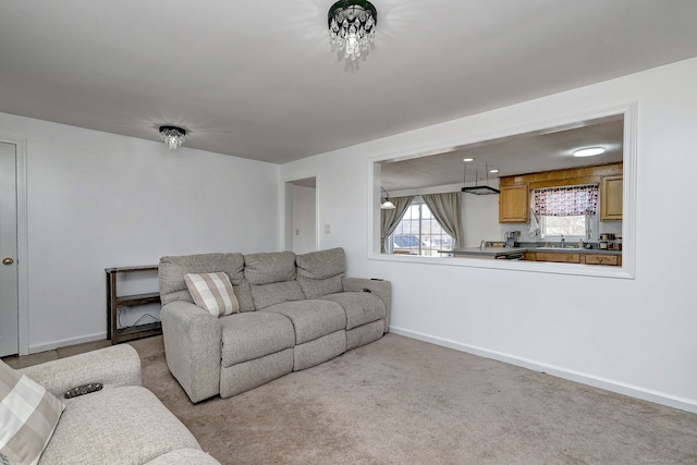 carpeted living room with sink