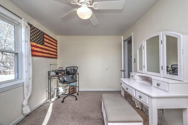 home office featuring light carpet and ceiling fan