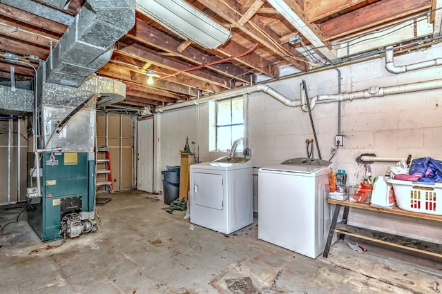 basement with heating unit and washing machine and clothes dryer