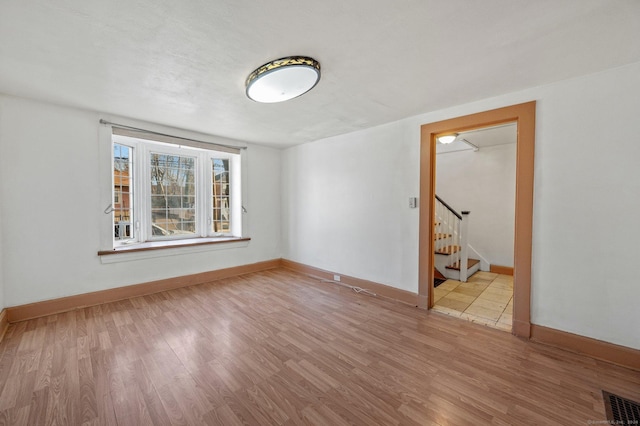 unfurnished room with light wood-type flooring