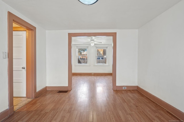 spare room with ceiling fan and light hardwood / wood-style flooring