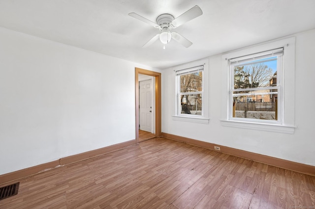 empty room featuring hardwood / wood-style floors and ceiling fan