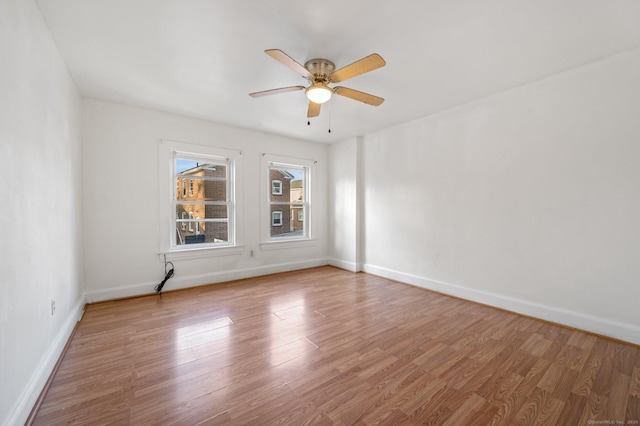 unfurnished room with ceiling fan and hardwood / wood-style flooring