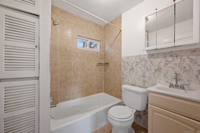 full bathroom with vanity, toilet, and tiled shower / bath