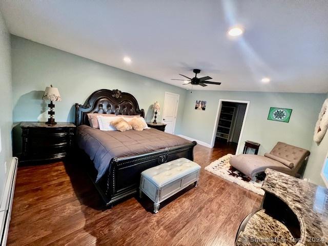 bedroom with ceiling fan, recessed lighting, a baseboard heating unit, baseboards, and dark wood finished floors