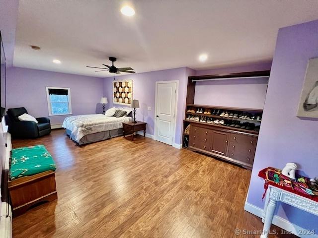 bedroom with a ceiling fan, recessed lighting, baseboards, and wood finished floors