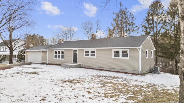 view of front of house with a garage and central air condition unit