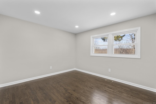 empty room with dark hardwood / wood-style floors