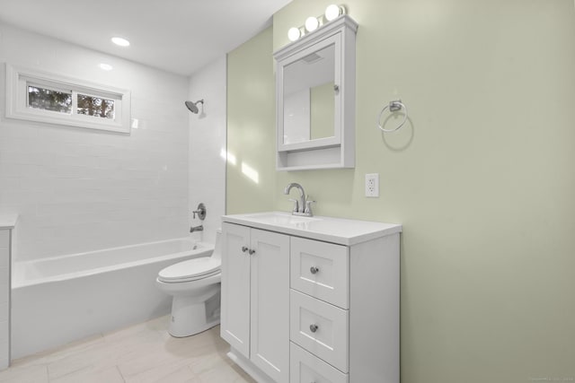 full bathroom featuring vanity, tiled shower / bath, tile patterned flooring, and toilet