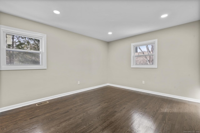 unfurnished room featuring dark hardwood / wood-style floors