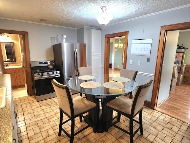 dining space with a chandelier, a textured ceiling, and ornamental molding