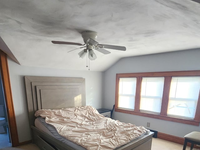 bedroom with ceiling fan, light carpet, and vaulted ceiling