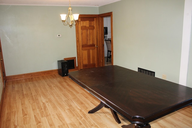 interior space featuring light hardwood / wood-style flooring and an inviting chandelier