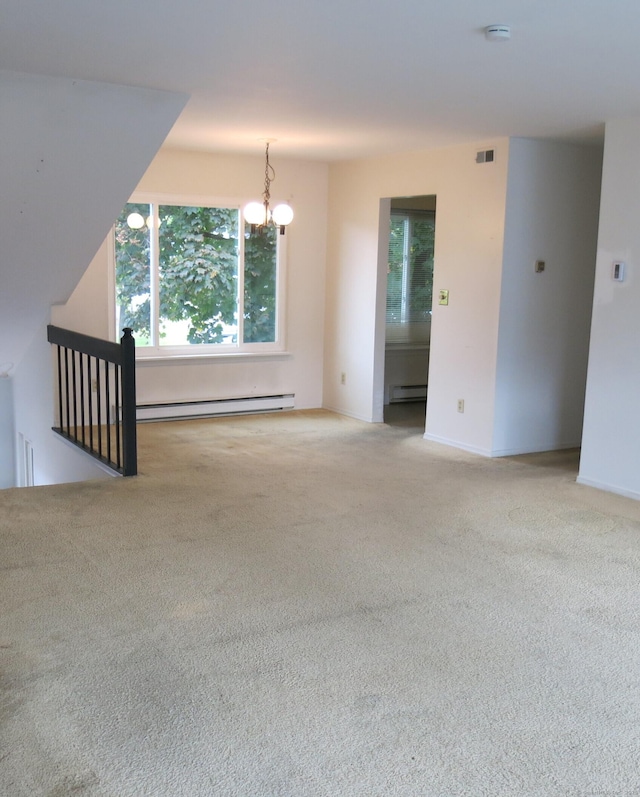 carpeted spare room featuring a baseboard radiator and a notable chandelier