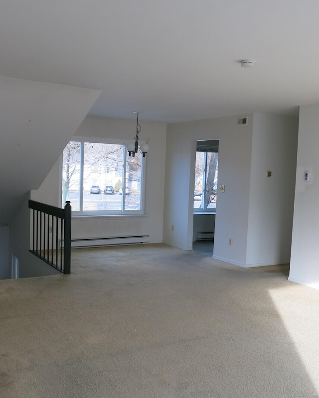 unfurnished living room featuring light colored carpet, a chandelier, and a baseboard radiator