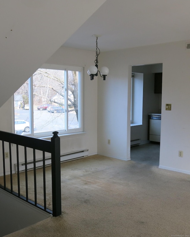 interior space with baseboard heating, carpet, and a notable chandelier